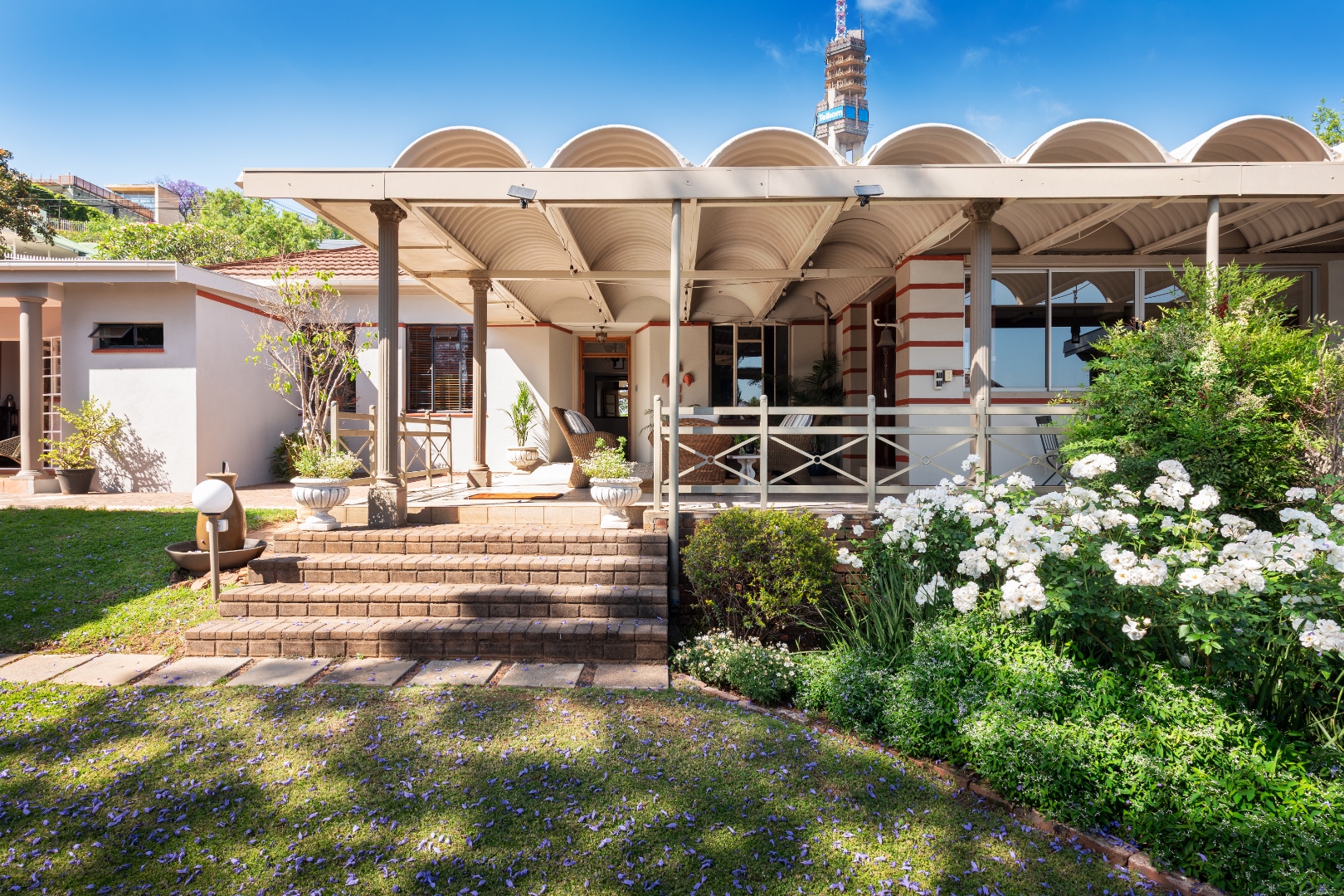Covered veranda entrance with wicker lounge seating