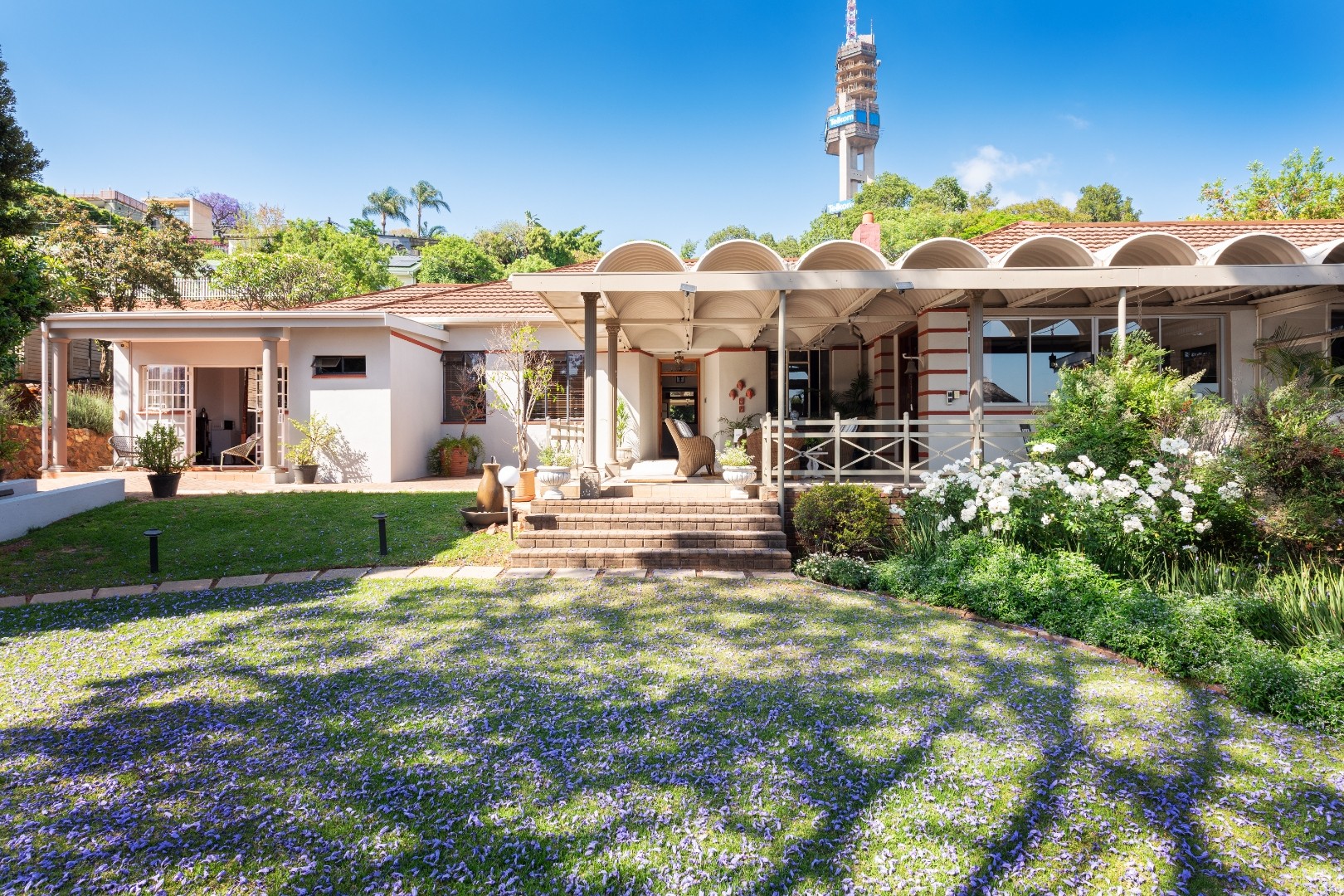House Falcon Guest Houses with its heritage exterior, arched verandah and jacaranda-shaded garden in Muckleneuk, Pretoria