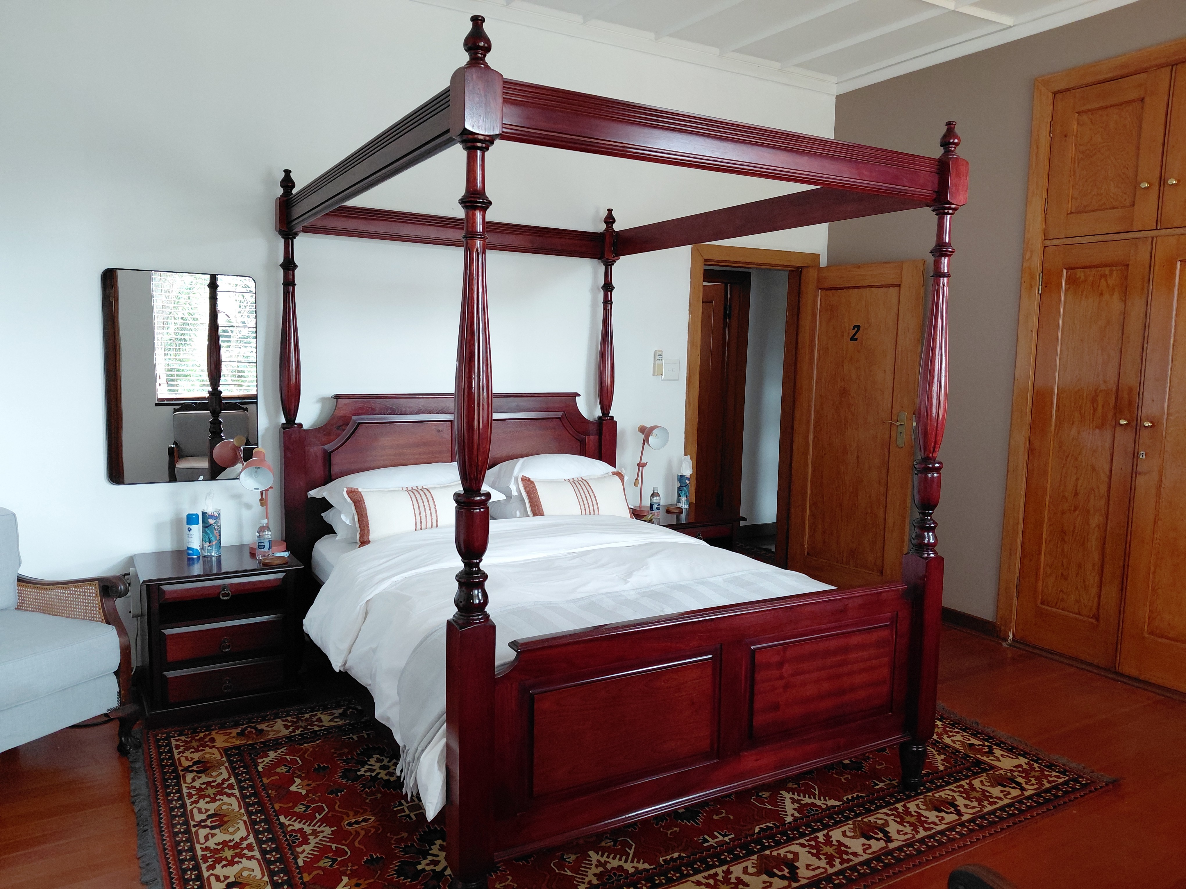 Standard Queen Room with rattan headboard and built-in wardrobes at House Falcon guest house Muckleneuk